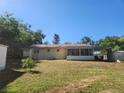 The home's large backyard features a patio, storage sheds, and mature trees at 5029 Eagles Nest Rd, Fruitland Park, FL 34731
