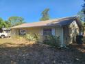 Side view of a yellow single story home with a simple, well-maintained exterior at 5029 Eagles Nest Rd, Fruitland Park, FL 34731