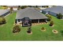 Expansive backyard with a screened lanai and lush greenery, perfect for outdoor living and entertaining at 5220 Horsford Path, The Villages, FL 32163