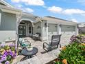Inviting front porch with outdoor seating, decorative plants, and a beautiful entrance leading to the home at 575 Wheelock St, The Villages, FL 32163