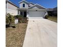 Beautiful two-story home with a two-car garage and landscaped front yard at 6846 Wilson Hammock Ave, Groveland, FL 34736