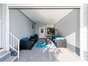 Covered patio with comfortable seating arrangement, offering a relaxing outdoor living space at 728 Tangerine Dr, The Villages, FL 32159