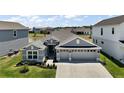 Beautiful single-story home with a large driveway, lush landscaping, and ample parking at 7669 Chastain Cir, Middleton, FL 34762