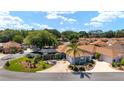 Lovely home with a screened-in pool, a patio with a fire pit, and a well-maintained front yard at 850 Oviedo Rd, Lady Lake, FL 32159