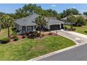 Aerial view of a lovely single-story home with a well-maintained lawn and landscaping at 8715 Se 176Th Lowndes Pl, The Villages, FL 32162
