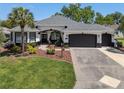 Beautiful single-story home with a well-kept lawn and a spacious driveway at 8715 Se 176Th Lowndes Pl, The Villages, FL 32162