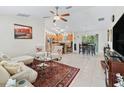 Open-concept floor plan showcasing a living room that flows into the kitchen and dining area at 9621 Se 168Th Maplesong Ln, The Villages, FL 32162