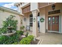Charming front porch with a water fountain, seating, and lush landscaping, creating a welcoming entrance at 1606 Mount Croghan Trl, The Villages, FL 32162