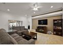 Comfortable living room featuring cozy fireplace and seamless access to the outdoor patio at 10282 Julia Isles Ave, Oxford, FL 34484