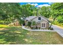 Inviting single-story home featuring a well-maintained lawn, stone detailing, and tasteful landscaping at 10851 Lantana Crst, Clermont, FL 34711