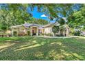 Charming single-story home with a large front lawn and stone facade accents at 10851 Lantana Crst, Clermont, FL 34711