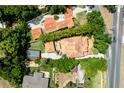 Bird's-eye view showcases the home's tile roof, sparkling pool, and surrounding greenery at 1196 Lakeshore Dr, Mount Dora, FL 32757