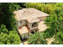 Aerial shot of a home with a unique barrel tile roof surrounded by mature trees for privacy at 1196 Lakeshore Dr, Mount Dora, FL 32757