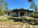 Unfinished single Gathering house shows the back patio and simple window trim at 12 Guava Terrace Radl, Ocklawaha, FL 32179