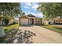 Attractive single-Gathering home with a spacious driveway, attached garage, and landscaped front yard at 12340 Ne 48Th Loop, Oxford, FL 34484