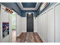 Stylish hallway with hardwood floors, board and batten walls, and decorative hooks at 13328 Lake Yale View Loop, Grand Island, FL 32735