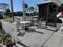 Inviting outdoor patio area with a white picket fence, perfect for relaxing and enjoying the fresh air at 1616 Lauren Ln, Lady Lake, FL 32159