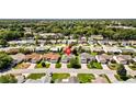 Aerial view of neighborhood showcasing the home's location among mature trees at 17076 Se 96Th Chapelwood Cir, The Villages, FL 32162