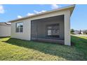 Enjoy outdoor living on this screened patio, perfect for relaxing and entertaining with a grassy backyard at 17386 Blazing Star Cir, Clermont, FL 34714