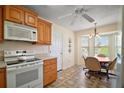 Bright kitchen features wood cabinetry, matching appliances, and a cozy breakfast nook at 1902 Del Norte Dr, Lady Lake, FL 32159