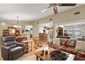 Inviting living room featuring hardwood floors, a ceiling fan, and a view to other rooms at 20 Ginger Cir, Leesburg, FL 34748