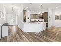 Modern kitchen features gray cabinets, white countertops, stainless steel appliances, and stylish pendant lighting at 2006 Oppenheimer Ct, The Villages, FL 34762
