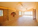 Brick sunroom with multiple windows offering an abundance of natural light and brick floor and wall at 2112 Robie Ave, Mount Dora, FL 32757