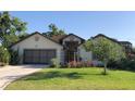 Charming single-story home with a well-manicured lawn and inviting front entrance at 21815 Tartan St, Leesburg, FL 34748