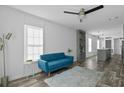 Bright living room with contemporary design, a plush blue sofa, and wood-look flooring at 2270 Griffin Rd, Bartow, FL 33830