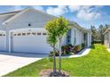 Well maintained home with landscaped yard and manicured lawn with fresh green grass and healthy plants at 27018 White Plains Way, Leesburg, FL 34748