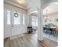 Bright foyer showcasing wood flooring and open access to the dining room at 2894 Southern Pines Loop, Clermont, FL 34711