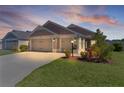 Lovely home showcasing a three-car garage and well-maintained landscaping at 2919 Gulley Ln, The Villages, FL 32163