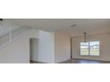 Bright living room featuring modern lighting and hardwood flooring at 307 Big Black Ln, Poinciana, FL 34759