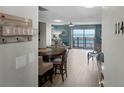 Inviting living area with wood-look tile, a view of oceanfront balcony, and beach decor at 4435 S Atlantic Ave # 114, Ponce Inlet, FL 32127