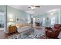 Bright living room with a ceiling fan, comfortable furniture, and stylish decor at 4671 Spring Grove Ln, Leesburg, FL 34748