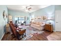 Cozy living room features a sliding glass door to a patio and comfortable seating at 4671 Spring Grove Ln, Leesburg, FL 34748