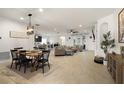 Bright, open-concept living space features dining area, modern lighting and seamless flow to the kitchen at 488 Avila Pl, Howey In The Hills, FL 34737