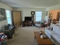 Bright living room with comfortable seating, neutral carpet, and large windows, creating a welcoming atmosphere at 4941 Tradition Dr, Lakeland, FL 33812