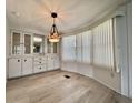Bright dining area with custom built-in cabinets and stylish hanging light fixture at 504 Hawthorne Blvd, Leesburg, FL 34748