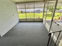 Enclosed screened in porch with carpeted flooring provides additional outdoor living space at 504 Hawthorne Blvd, Leesburg, FL 34748