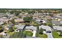 Aerial view of property showcasing the home's location in a neighborhood with mature trees and well-kept homes at 517 San Pedro Dr, Lady Lake, FL 32159