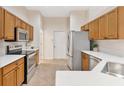 Bright kitchen with stainless steel appliances, white countertops, and wood cabinets at 5209 Grove Mnr, Lady Lake, FL 32159