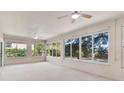 Bright sunroom featuring wall-to-wall windows offering natural light and outdoor views at 5209 Grove Mnr, Lady Lake, FL 32159