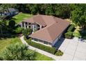 An aerial view shows the roof and driveway of this beautiful home at 5306 Greens Dr, Lady Lake, FL 32159