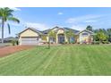 Charming single-story home with a lush green lawn and well-maintained landscaping at 5433 County Road 125, Wildwood, FL 34785