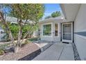 View of the front entry, walkway, and meticulously kept landscape and garden at 5614 King James Ave, Leesburg, FL 34748