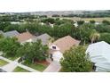 An elevated view of a home showcasing a lush backyard and sprawling neighborhood at 807 Wolf Creek St, Clermont, FL 34711
