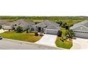 Charming one story home with a manicured lawn, long driveway and lush landscaping at 1016 Pickering Path, The Villages, FL 32163