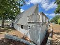 A home's back view showcases a private upper deck, gray siding, and surrounding greenery at 10301 Us Highway 27 # 63, Clermont, FL 34711
