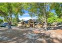 Charming single-story home nestled among mature trees, features a cozy entrance, and a well-maintained landscape at 10640 Parkway Dr, Clermont, FL 34711